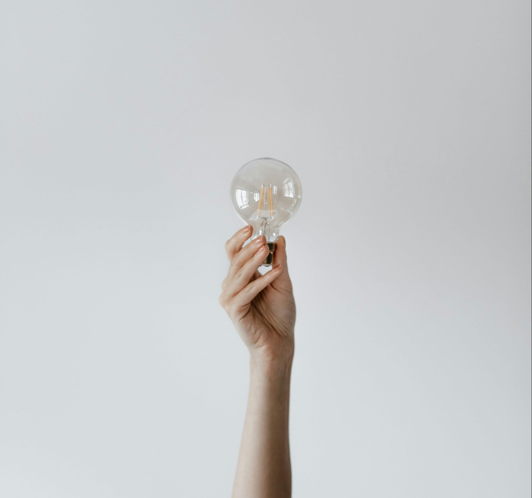 hand holding light bulb